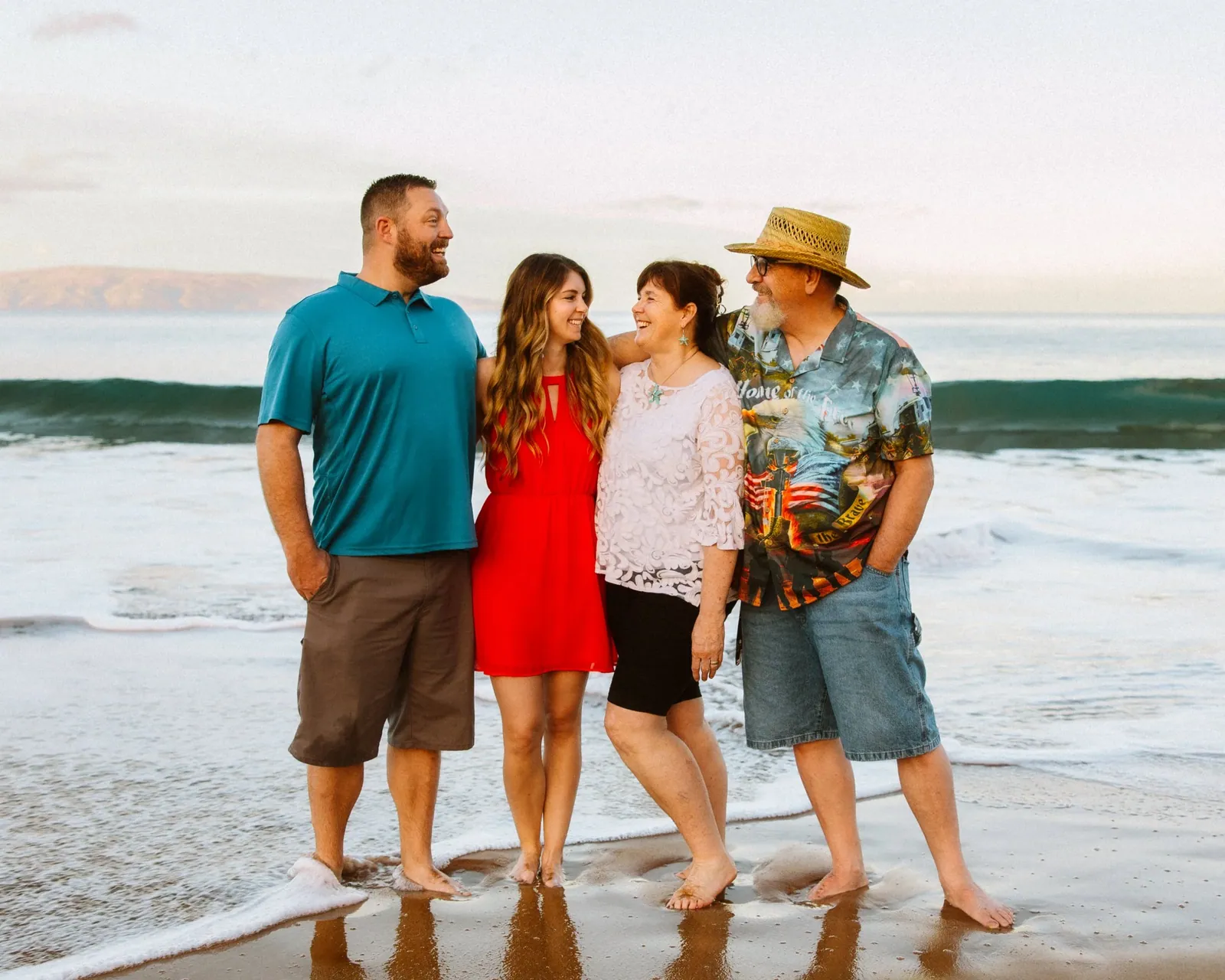 Family group photographed at the water's edge on a Maui beach