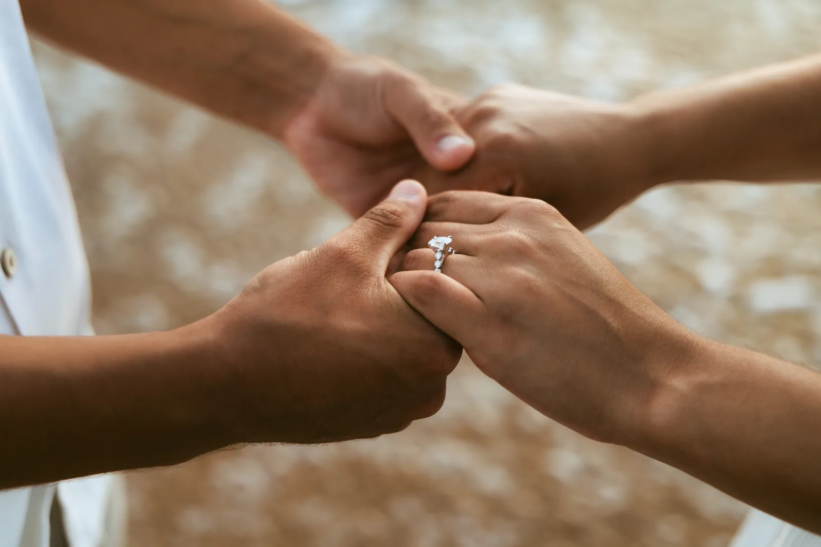 The ring going onto her finger, photographed close