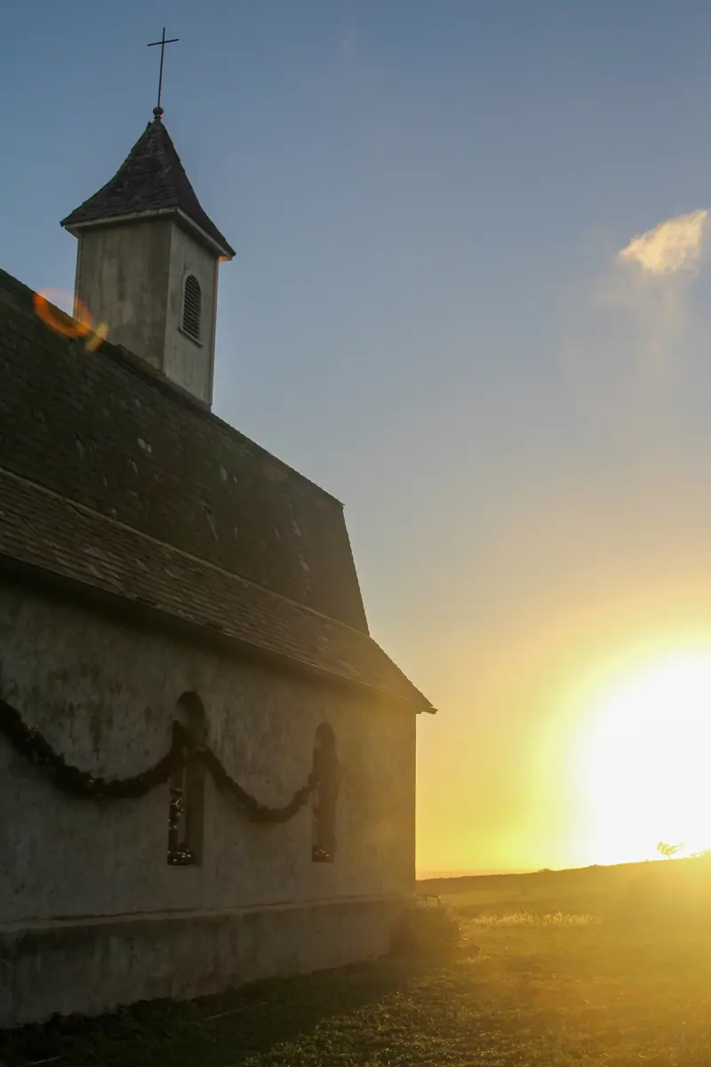 A small Hana church silhouetted at sunset